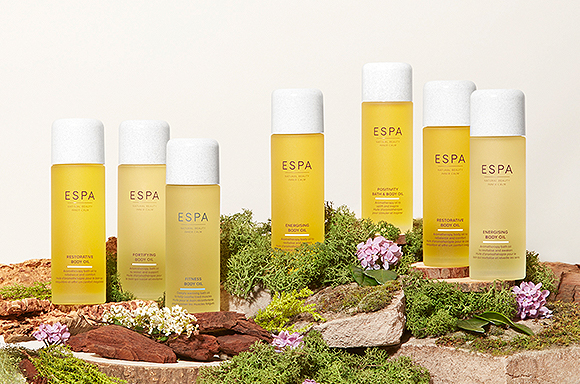 ESPA products showcase with grass and moss surounding them