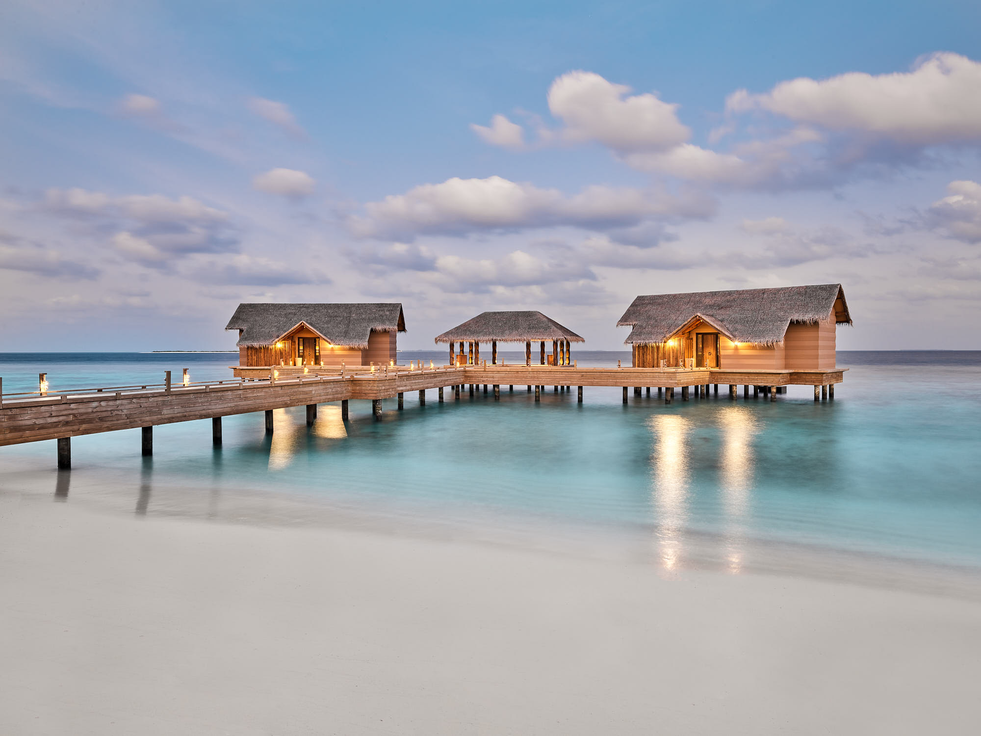 holiday houses joined by wooden bridges standing over the water