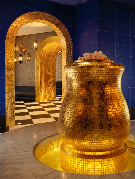 golden vase in a room with blue marbled walls