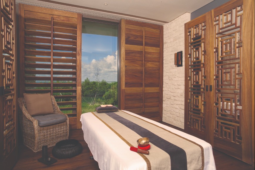 massage room with a window overlooking a yard