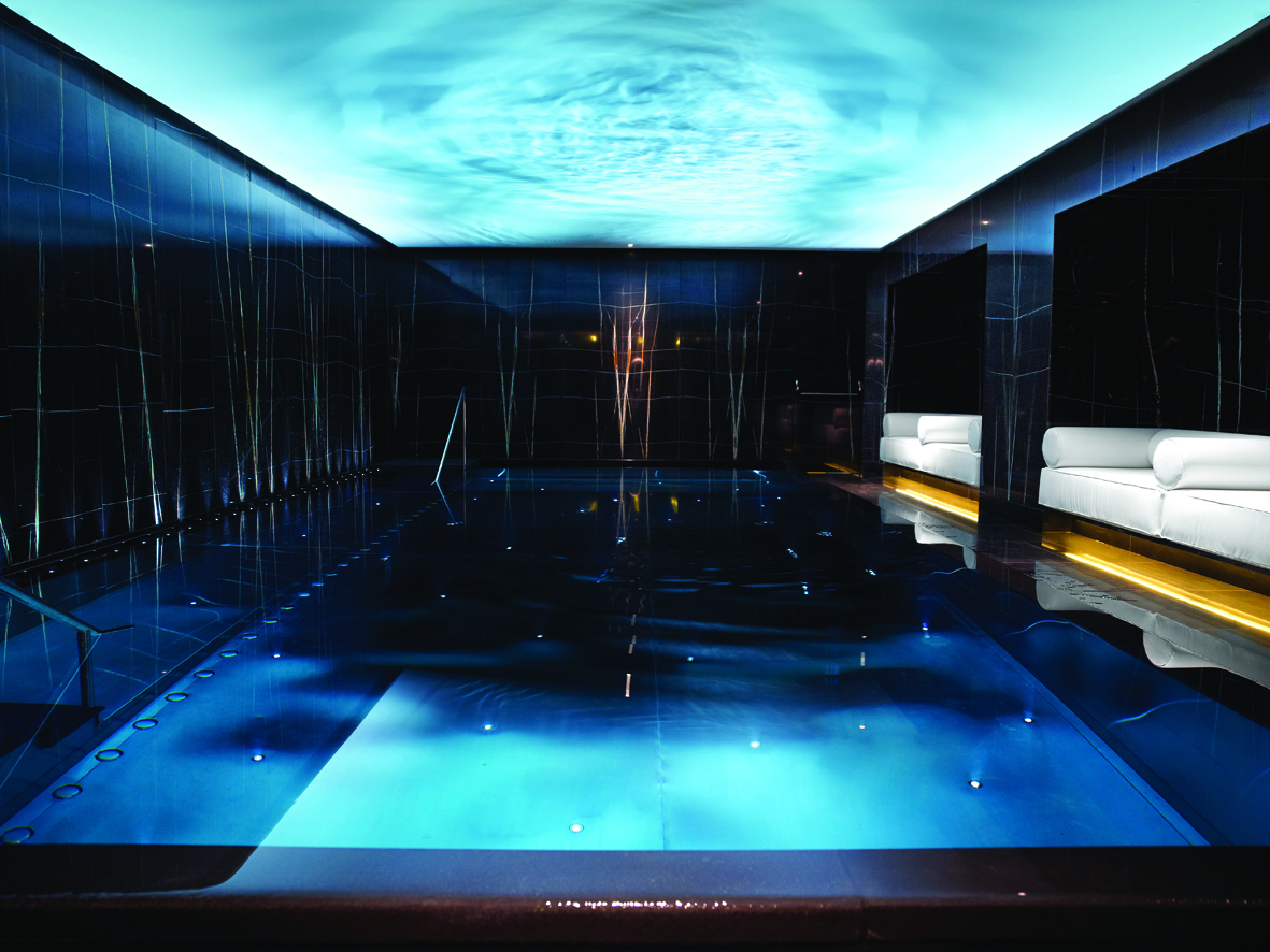 indoor pool surrounded by dark marble walls
