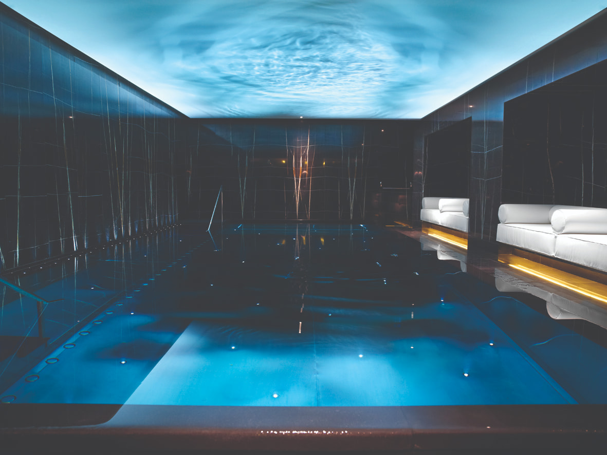 indoor pool surrounded by dark marble walls